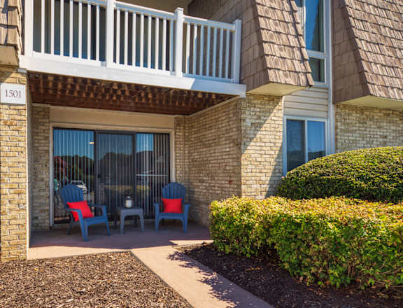 a patio with chairs outside of a building at Bayville Apartments in Virginia Beach, 23455