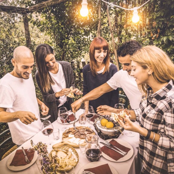 a group of people sitting around a table eating food at South Falls Tower, Richmond, VA, 23224