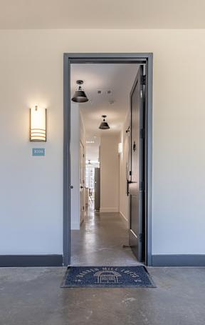 A hallway with a doorway leading to another room.