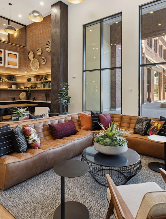 A modern living room with a large sectional sofa and a coffee table.