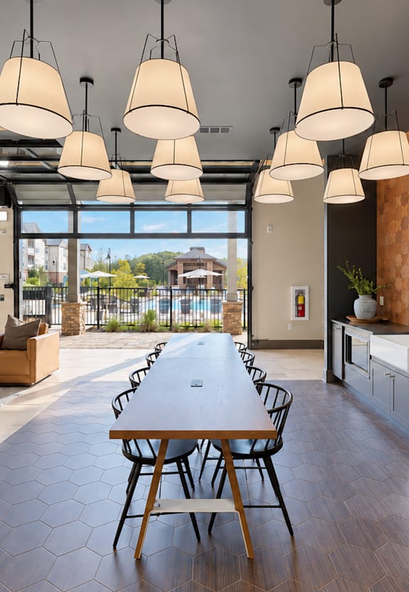 A modern kitchen with a wooden table and chairs.