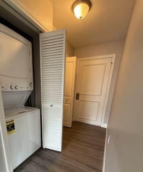 a small bathroom with a washer and dryer in it at Hidden Brook Apartment Homes Apartments, New Bedford, Massachusetts
