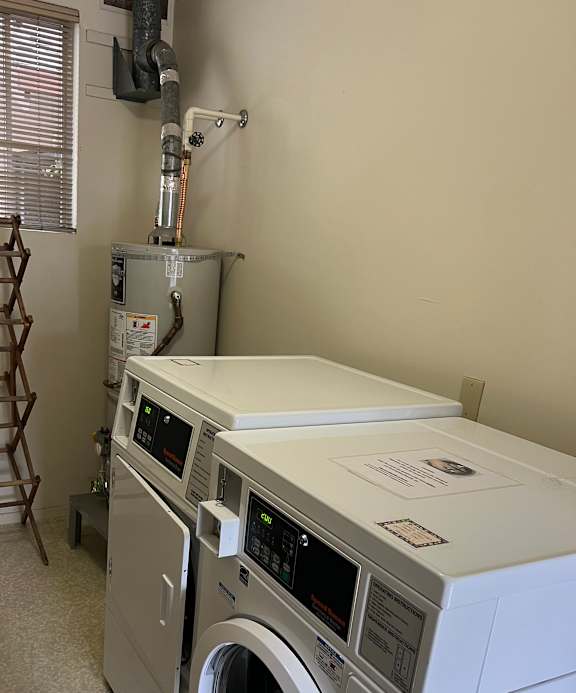 A washing machine is installed in a wall.