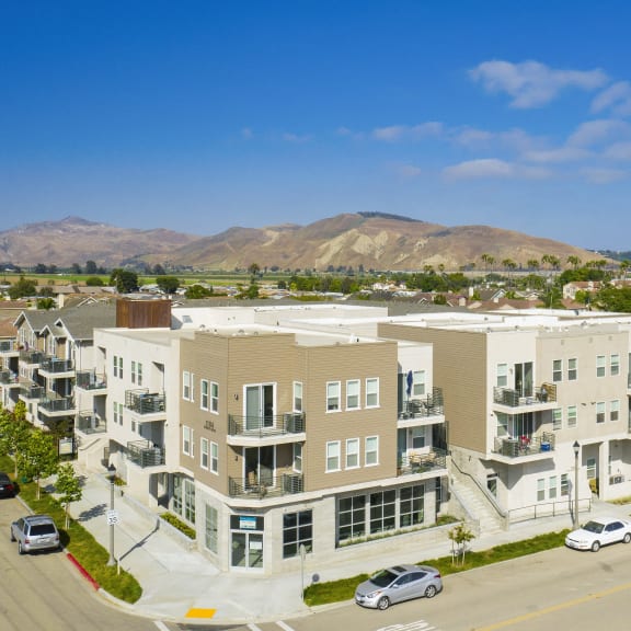 an aerial view of an apartment complex with mountains in the background