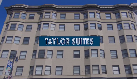 A building with the words "Taylor Suites" on it.