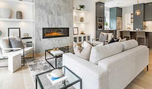 A modern living room with a fireplace and a white sofa.