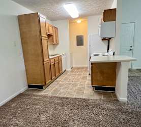 an empty kitchen with a counter and a refrigerator at Shenandoah Properties in Lafayette, IN 47905