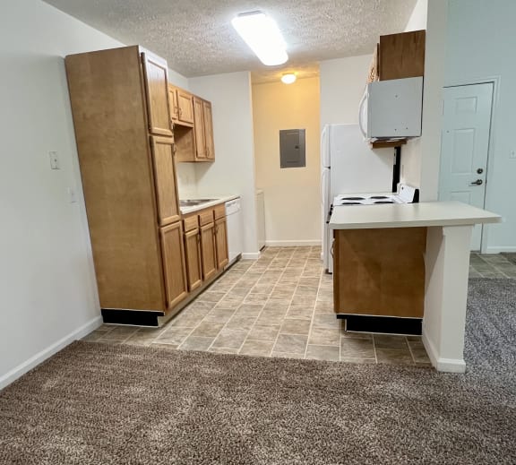 an empty kitchen with a counter and a refrigerator at Shenandoah Properties in Lafayette, IN 47905