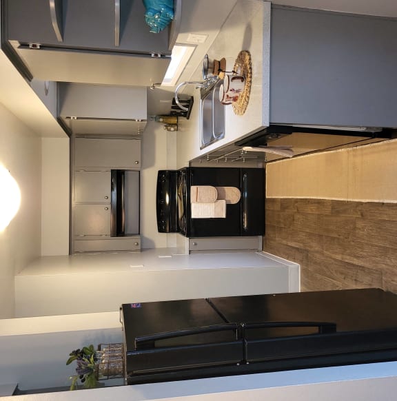 a kitchen with a stove top oven and a microwave