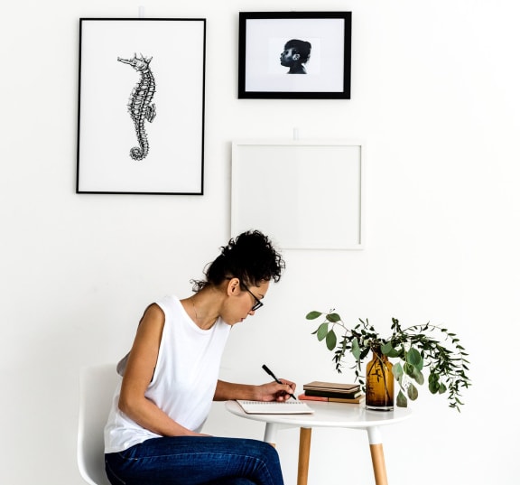 Woman sitting at a desk writing