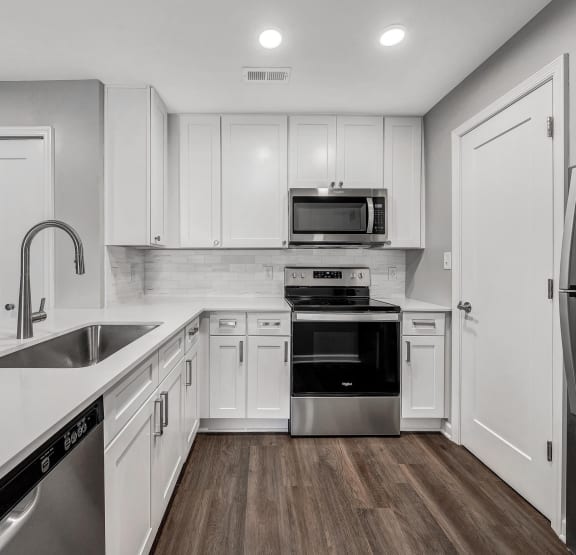 an empty kitchen with white cabinets and stainless steel appliances at WaterFront Apartments, Virginia Beach, 23453
