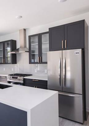 A modern kitchen with a white countertop and stainless steel appliances.at The Franklin at Westfield, Westfield, NJ 07090