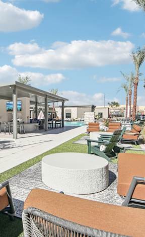 a lounge area with couches and chairs and tables at The Maddox Luxury Apartment Homes, Buckeye, AZ 85326
