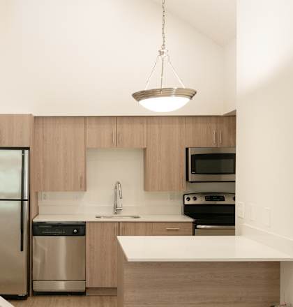 A kitchen with a staircase leading to the upper floor.