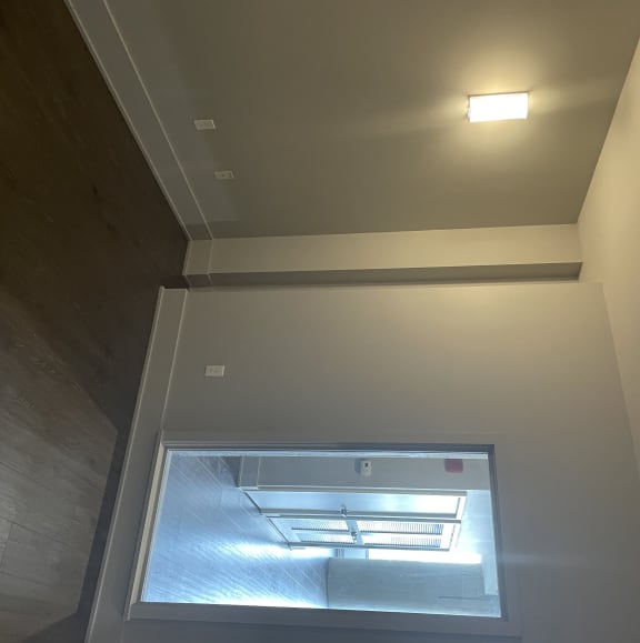 A sizable bedroom with modern sconces large enough to accomodate a King size bed with end tables.