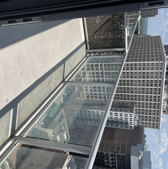 Glass and stainless-steel railings on the patios provide minimal obstruction to the outstanding view of the city and plaza below.