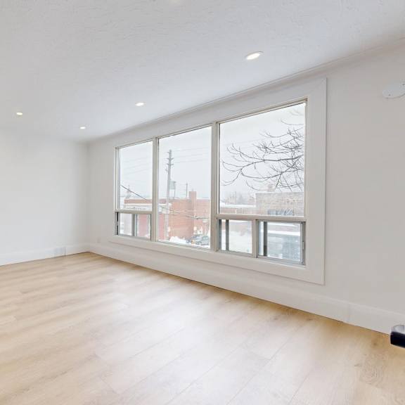 A room with a fireplace and a chair.