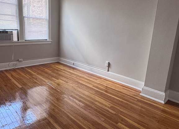 A room with a ceiling fan and a window.