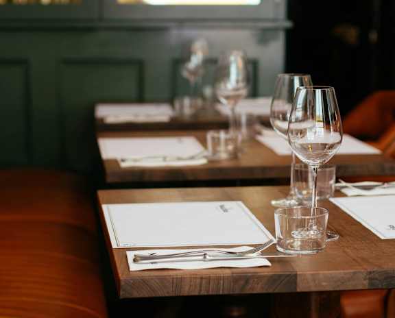 A table set for a meal with glasses and napkins.