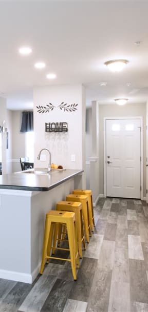a kitchen with white cabinets and a black stove and refrigerator
