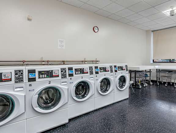 A row of washing machines in a laundromat.