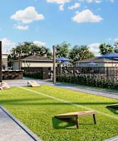 grassy area with cornhole boards