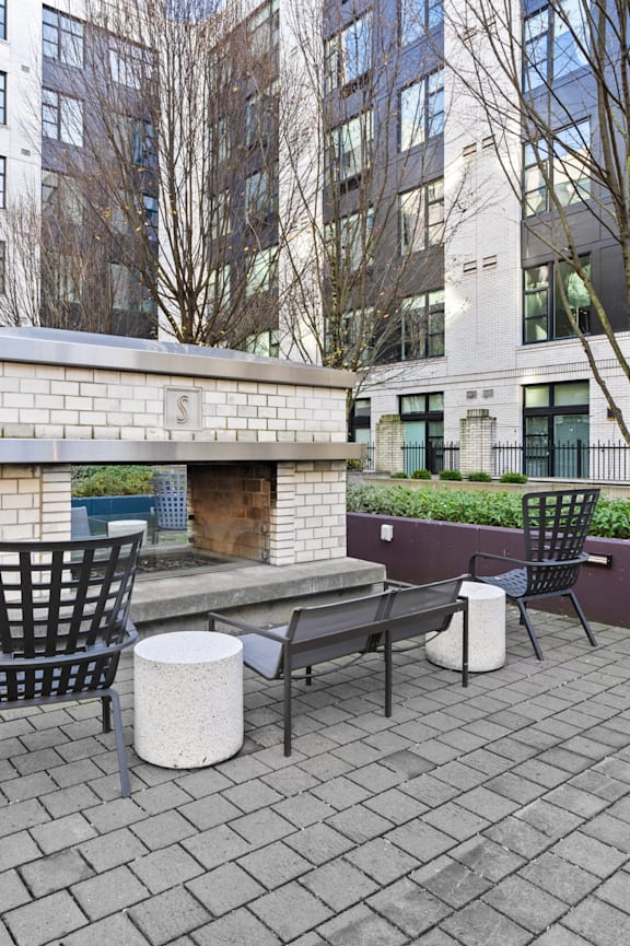 a patio with furniture and an outdoor fireplace at The Parker in Oregon 97209