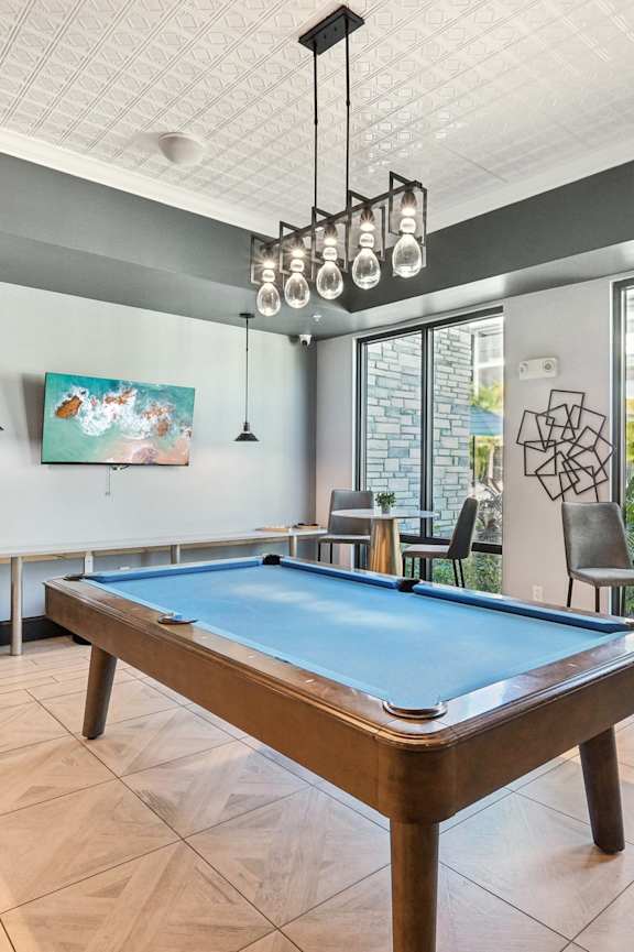 A patio with a television and outdoor furniture at AxisOne Apartments in Stuart, FL 34994