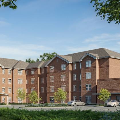 A large, modern building with a brown facade and a driveway in front. at Evergreen Heights Apartments, Toledo, OH, 43614
