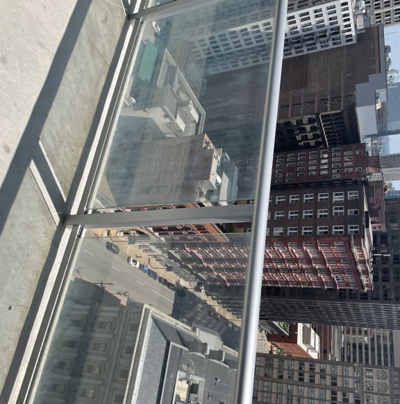 Glass and stainless-steel railings on the patios provide minimal obstruction to the outstanding view of the city and plaza below.