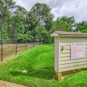 a dog park with a dog kennel and a dog house