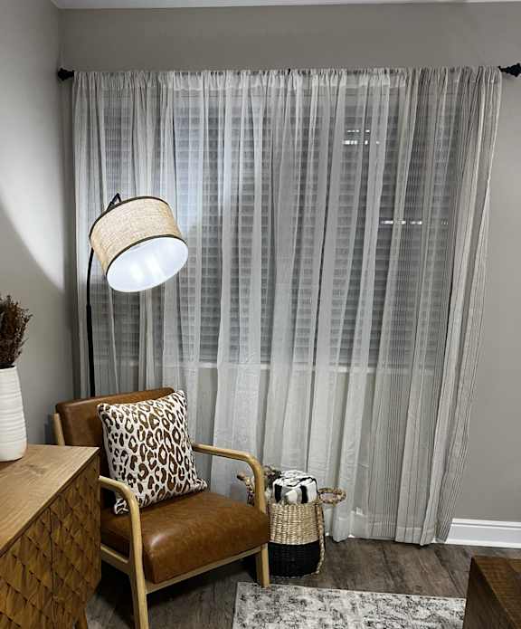 a beauty room with a chair and a table and a lamp