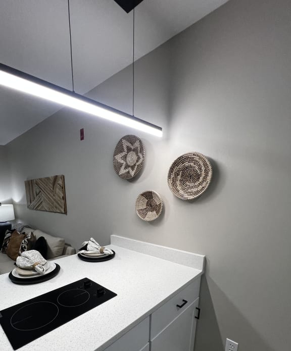 a small kitchen with a stove and a sink and a ceiling light