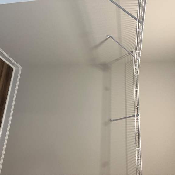 A white shelf with a glass shelf on it.