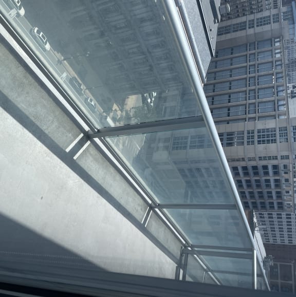 Glass and stainless-steel railings on the patios provide minimal obstruction to the outstanding view of the city and plaza below.