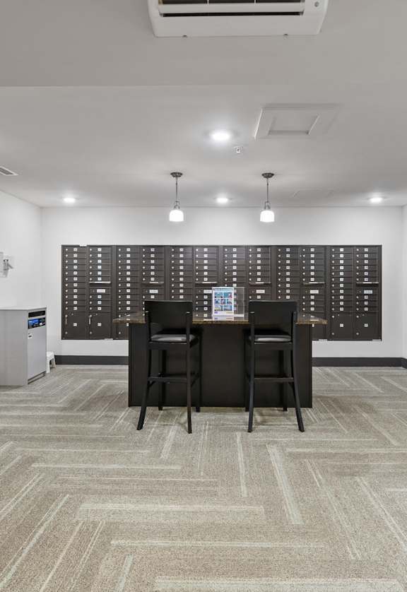 a conference room with a table and chairs in front of a wall of wine racks
