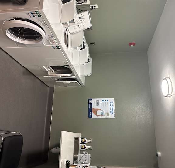 A row of washing machines in a laundromat.