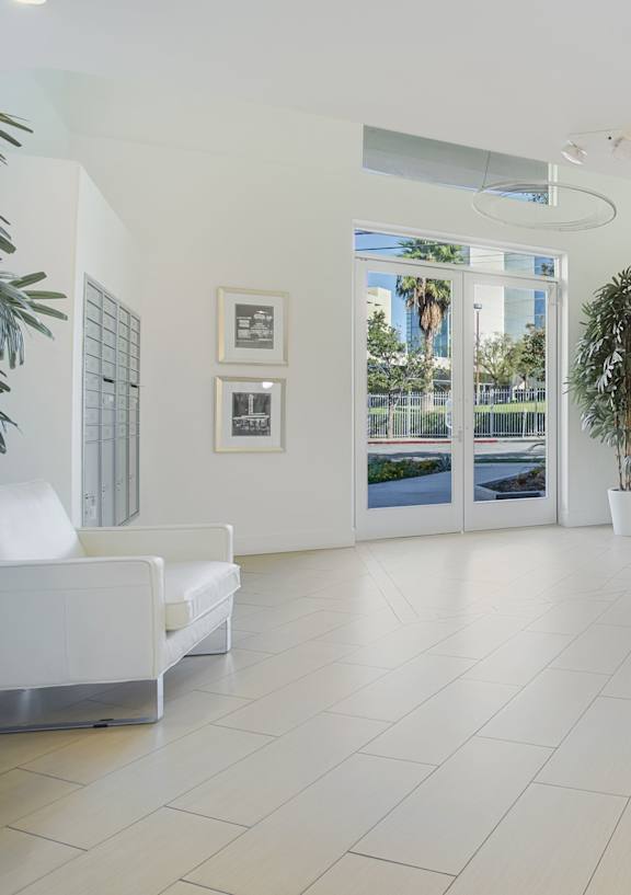 A white room with a table and chairs and a door.