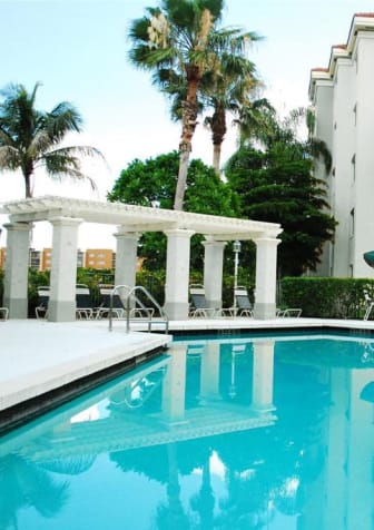 Pool with lounge chairs Heron Pointe Apartments Miramar Florida