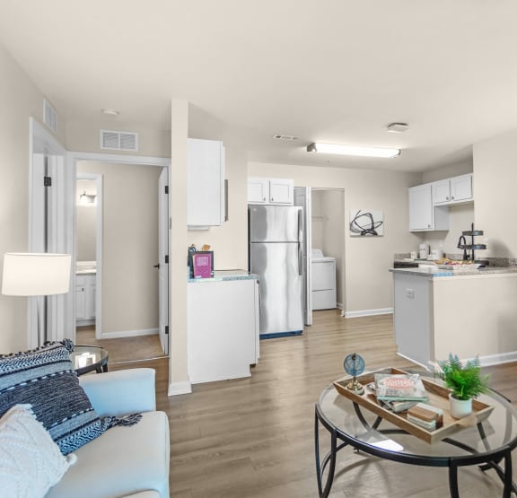 a living room and kitchen with a couch and a table