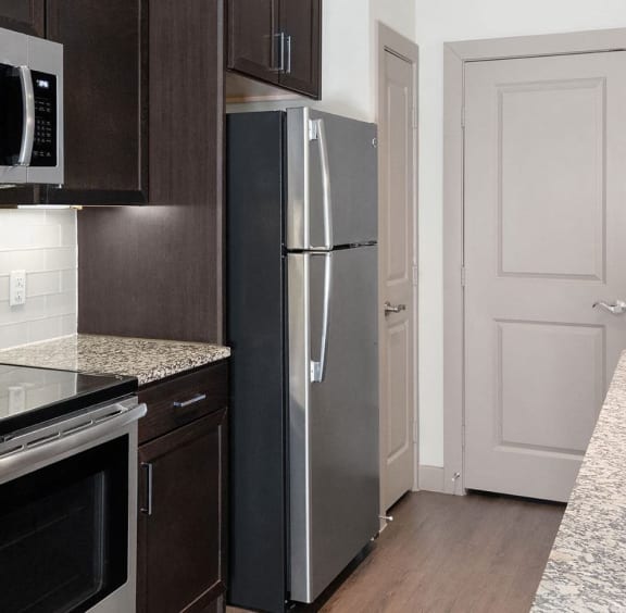 a kitchen with granite counter tops and stainless steel appliances