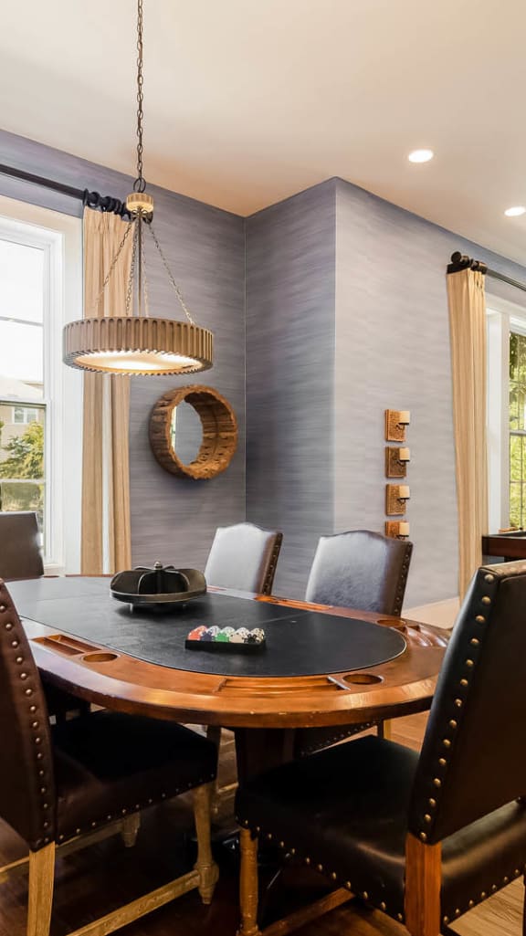 Inside Alexander Village's Game Room with a poker table and 6 chairs