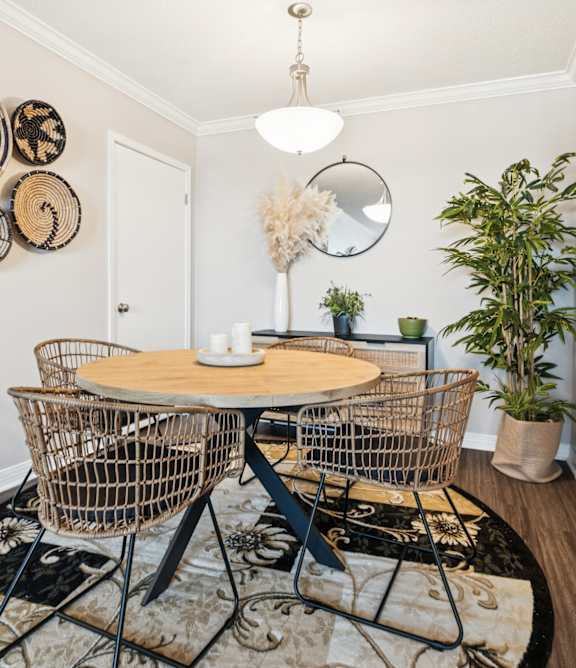A dining room with a round table and chairs at Esplanade at City Park, New Orleans, 70119