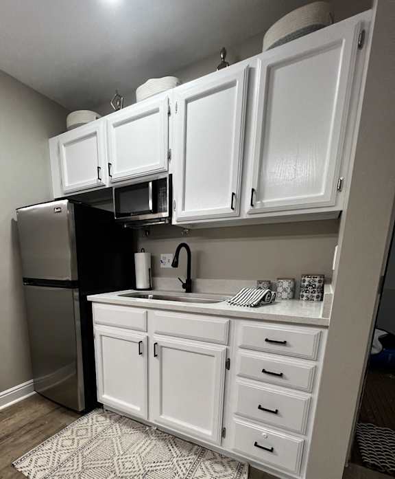 an overhead view of a kitchen with white cabinets