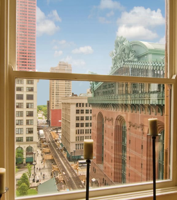 a view of the city from a window in a hotel room