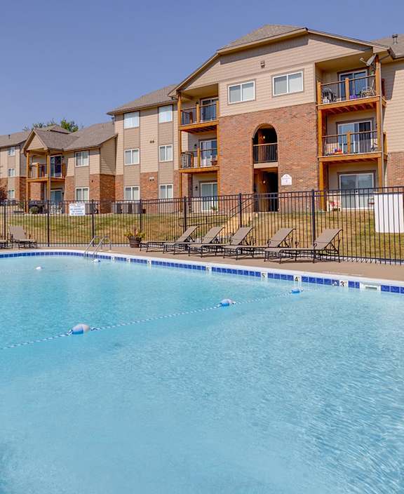 Community pool at Regency Woods Apartments, surrounded by a relaxing poolside area.