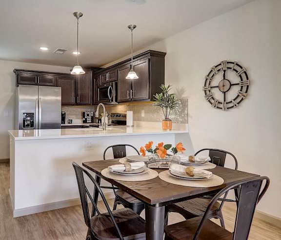 an open kitchen and dining room with a table and chairs