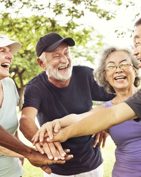 group of people standing in a circle with their hands together at Creston Point, Seattle, Washington