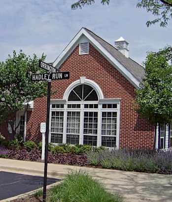 A sign for Hadley Run is in front of a brick building.