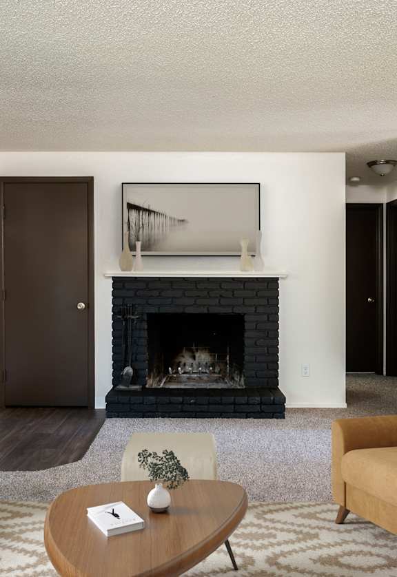 a living room with a fireplace and a couch and a coffee table